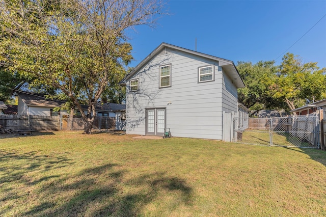 rear view of property featuring a yard