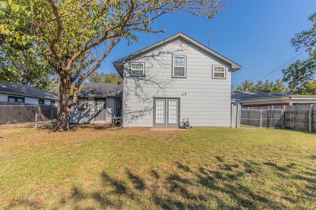 rear view of property with a lawn