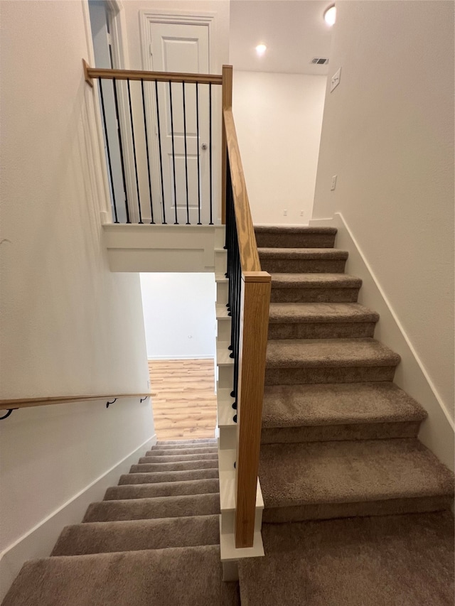 stairway featuring hardwood / wood-style flooring