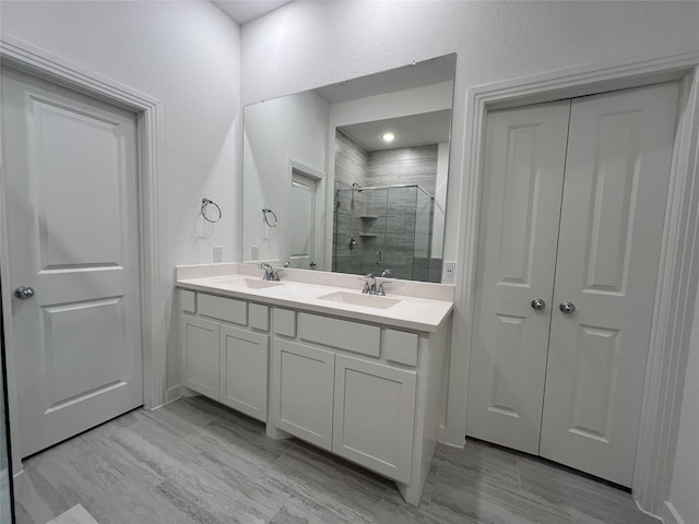 bathroom with a shower with door and vanity