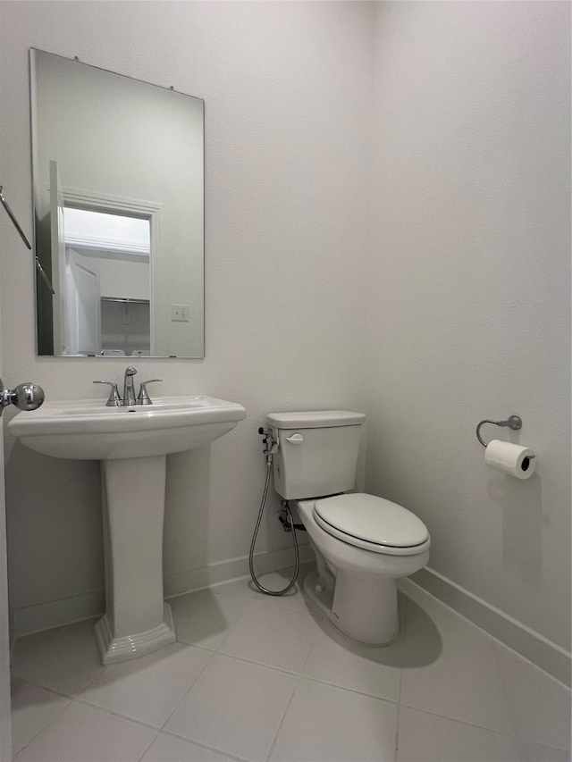 bathroom featuring sink, toilet, and tile patterned floors