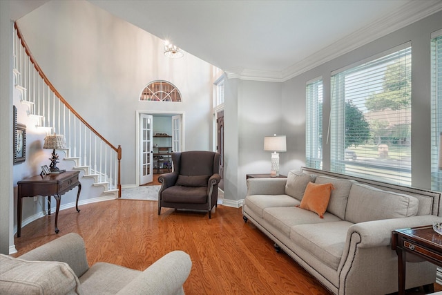 living room featuring light wood-type flooring and crown molding