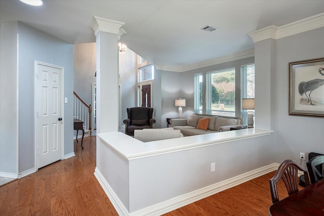 living room with hardwood / wood-style flooring and ornamental molding