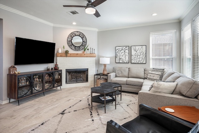 living room featuring ceiling fan, ornamental molding, and a fireplace