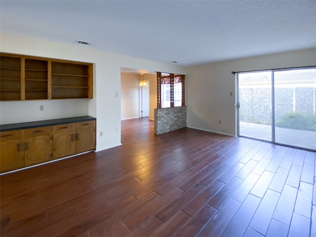 unfurnished living room with dark hardwood / wood-style flooring