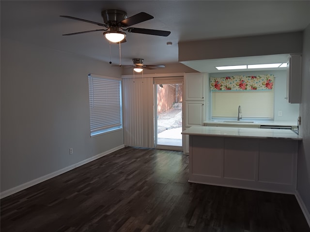 kitchen with white cabinetry, dark hardwood / wood-style floors, sink, and ceiling fan