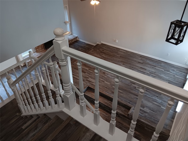 stairway featuring wood-type flooring