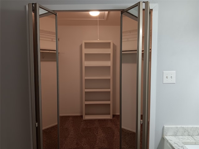 spacious closet featuring dark carpet