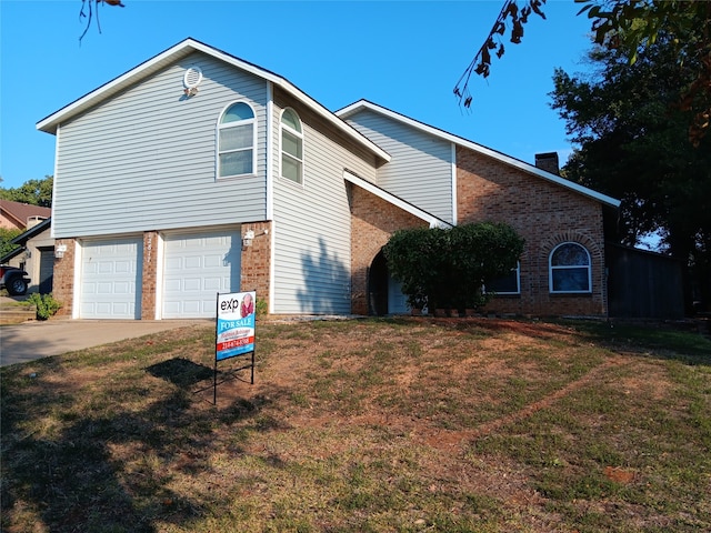 view of home's exterior with a garage and a yard