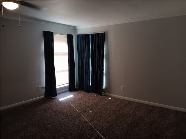 unfurnished room with crown molding, dark colored carpet, and ceiling fan