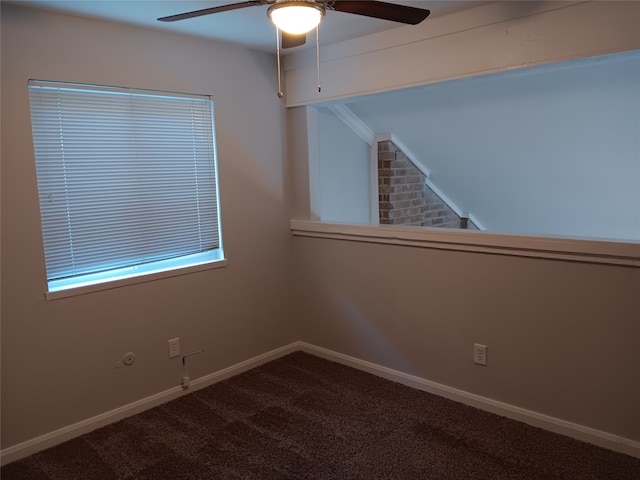 carpeted spare room with ceiling fan