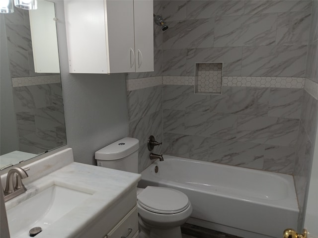 full bathroom featuring tiled shower / bath combo, vanity, and toilet