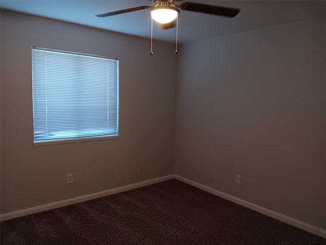 spare room featuring ceiling fan and carpet floors