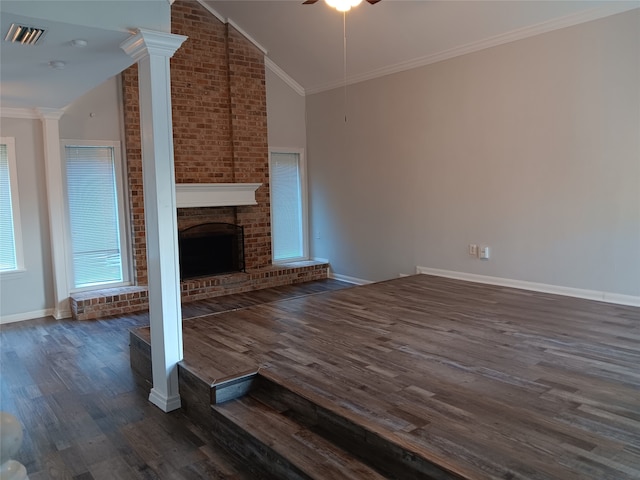 unfurnished living room featuring high vaulted ceiling, ceiling fan, dark hardwood / wood-style floors, crown molding, and decorative columns