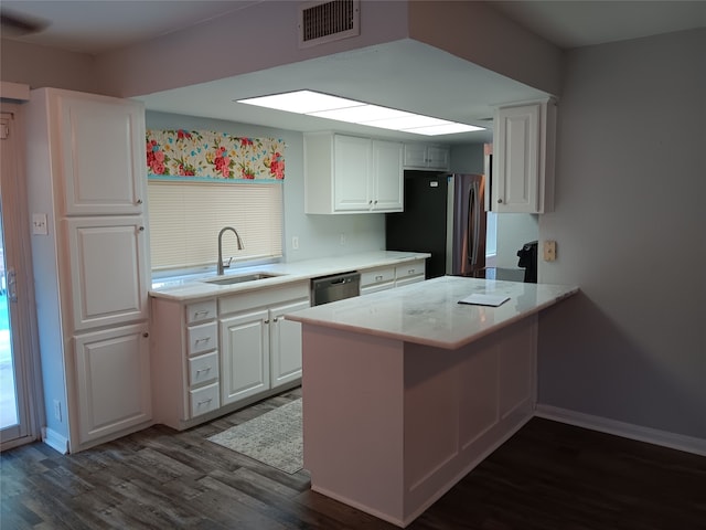 kitchen featuring white cabinets, kitchen peninsula, sink, stainless steel appliances, and dark hardwood / wood-style flooring