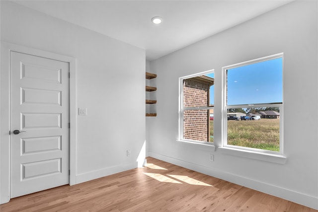 spare room featuring light hardwood / wood-style flooring