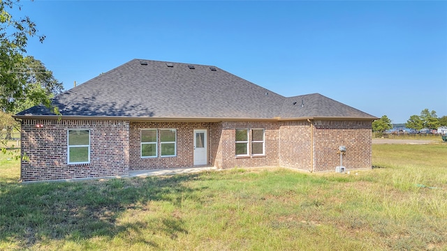 rear view of property with a lawn