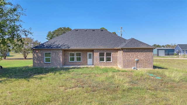 back of property with a yard and a garage