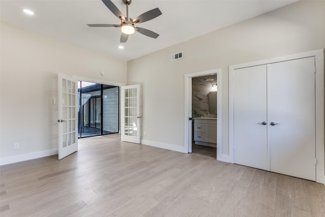 unfurnished bedroom with french doors, ensuite bathroom, light hardwood / wood-style flooring, a closet, and ceiling fan