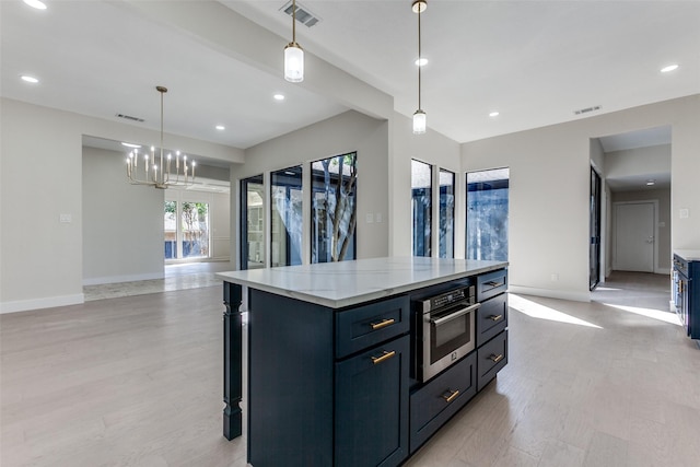 kitchen with pendant lighting, oven, a center island, light stone countertops, and light wood-type flooring