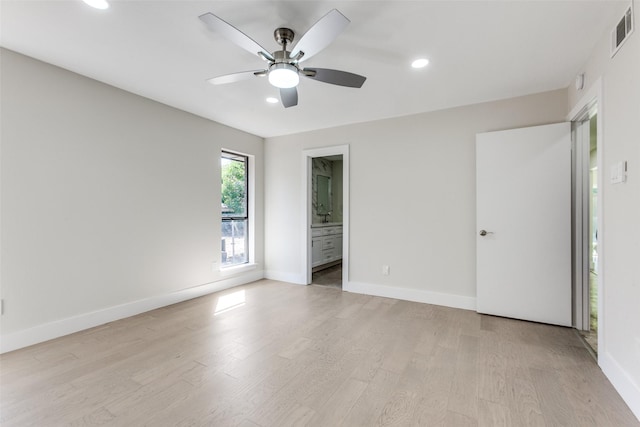 spare room featuring ceiling fan and light hardwood / wood-style flooring