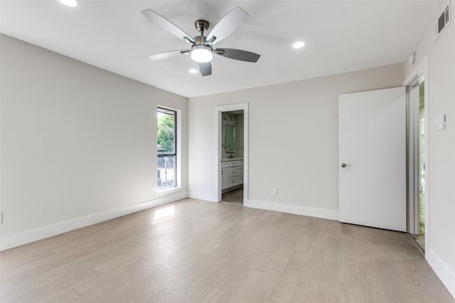 empty room featuring ceiling fan and light hardwood / wood-style flooring