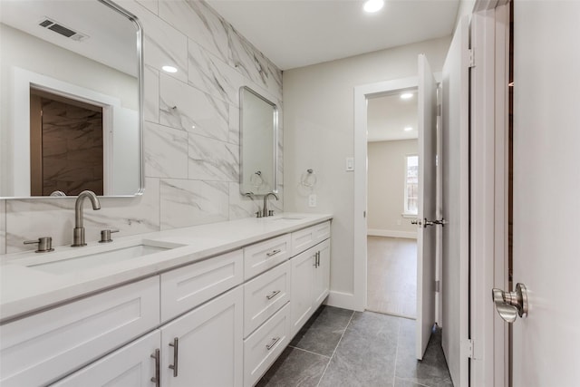 bathroom with tasteful backsplash and vanity