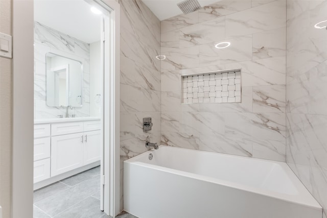 bathroom featuring vanity, tiled shower / bath, and tile patterned floors