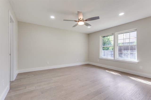 unfurnished room with ceiling fan and light wood-type flooring