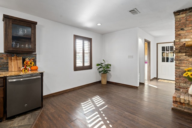 interior space featuring dishwasher, dark wood-type flooring, light stone counters, and dark brown cabinets