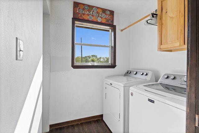 laundry area featuring separate washer and dryer, cabinets, and dark hardwood / wood-style flooring