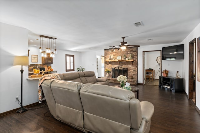 living room featuring dark wood-type flooring, a brick fireplace, and ceiling fan