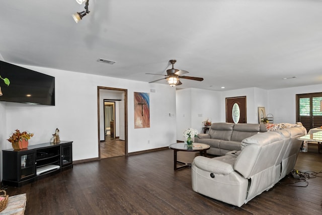 living room with ceiling fan and dark hardwood / wood-style flooring