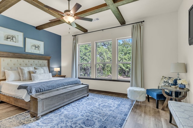 bedroom featuring wood-type flooring, beamed ceiling, coffered ceiling, and ceiling fan