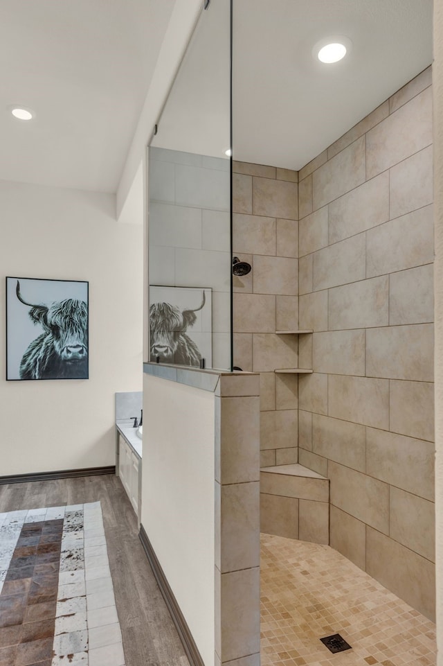 bathroom with independent shower and bath and hardwood / wood-style flooring