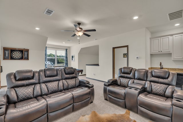 home theater room with light carpet and ceiling fan