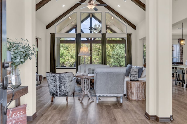 interior space featuring ceiling fan, beamed ceiling, hardwood / wood-style flooring, and high vaulted ceiling