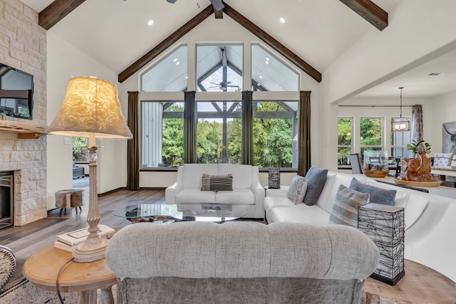 living room featuring hardwood / wood-style flooring, beamed ceiling, and high vaulted ceiling