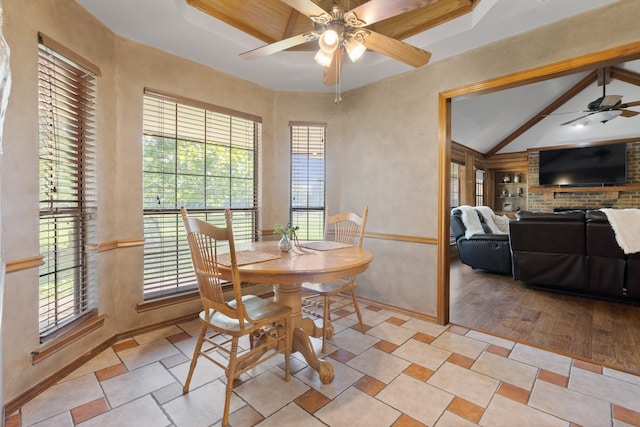 dining room with lofted ceiling with beams, a healthy amount of sunlight, ceiling fan, and light hardwood / wood-style floors