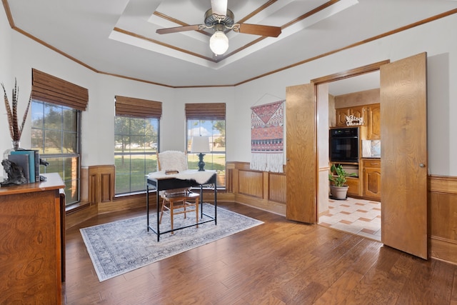 dining space with ornamental molding, ceiling fan, wood walls, and dark hardwood / wood-style flooring