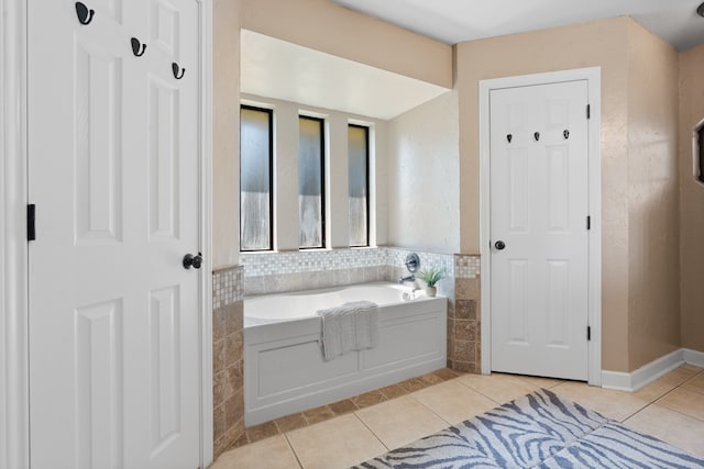 bathroom with tile patterned floors and a tub