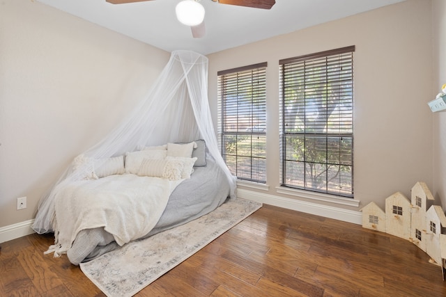 bedroom with ceiling fan and hardwood / wood-style flooring