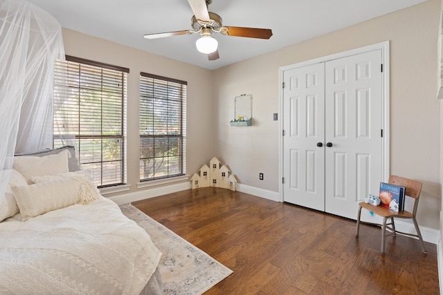 bedroom with ceiling fan, a closet, and dark hardwood / wood-style floors