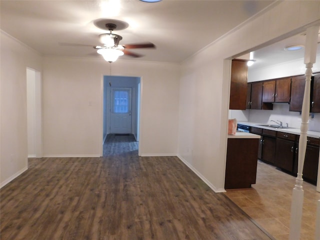 kitchen with ceiling fan, dark brown cabinetry, hardwood / wood-style flooring, sink, and crown molding