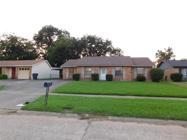 ranch-style home with a garage and a front lawn