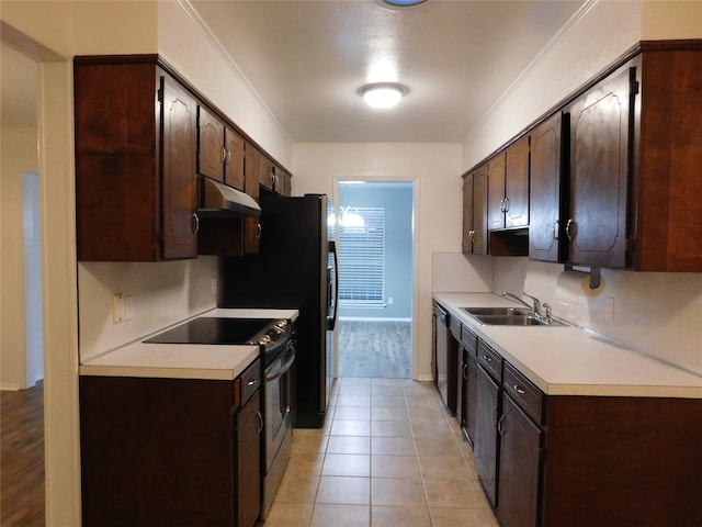 kitchen with stainless steel appliances, dark brown cabinetry, sink, and light tile patterned floors