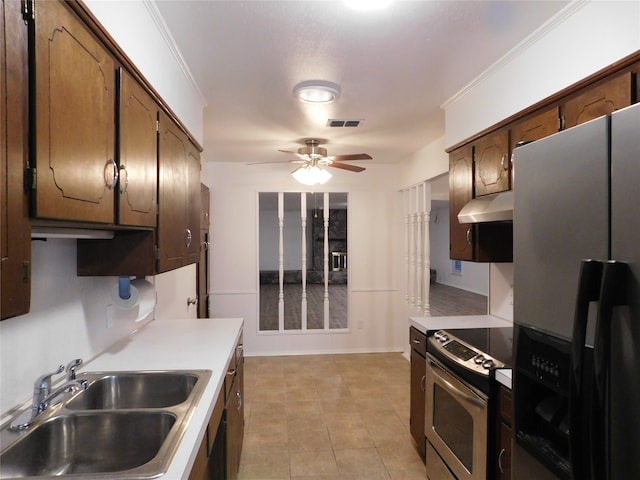 kitchen with ceiling fan, sink, stainless steel appliances, ornamental molding, and light tile patterned floors