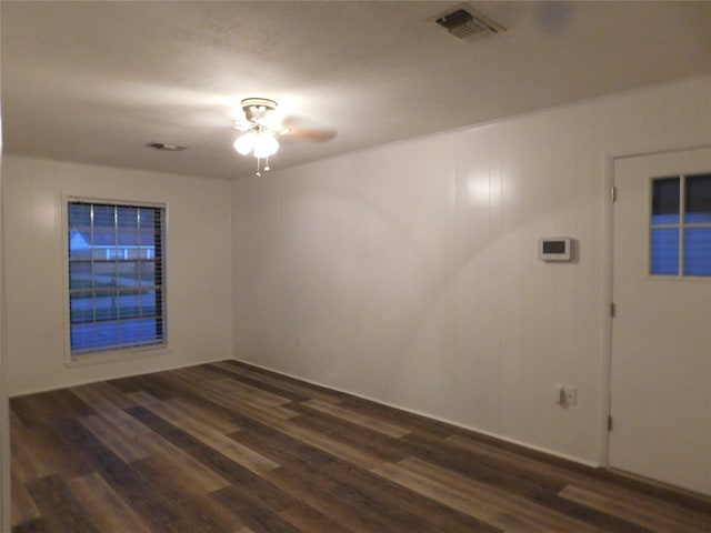 empty room featuring ceiling fan and dark hardwood / wood-style flooring