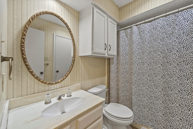 bathroom featuring walk in shower, vanity, and toilet