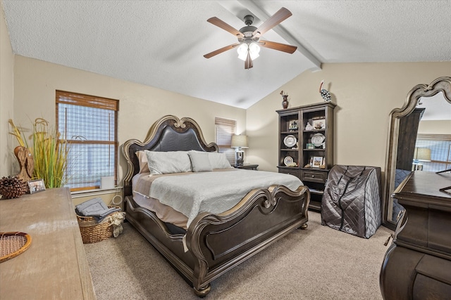 carpeted bedroom featuring ceiling fan, vaulted ceiling with beams, and a textured ceiling